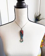 Sonoran jasper pendant worn on chain to show length and teardrop shape
