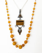 Chunky filigree gemstone pendant with tiger’s eye bead fringe