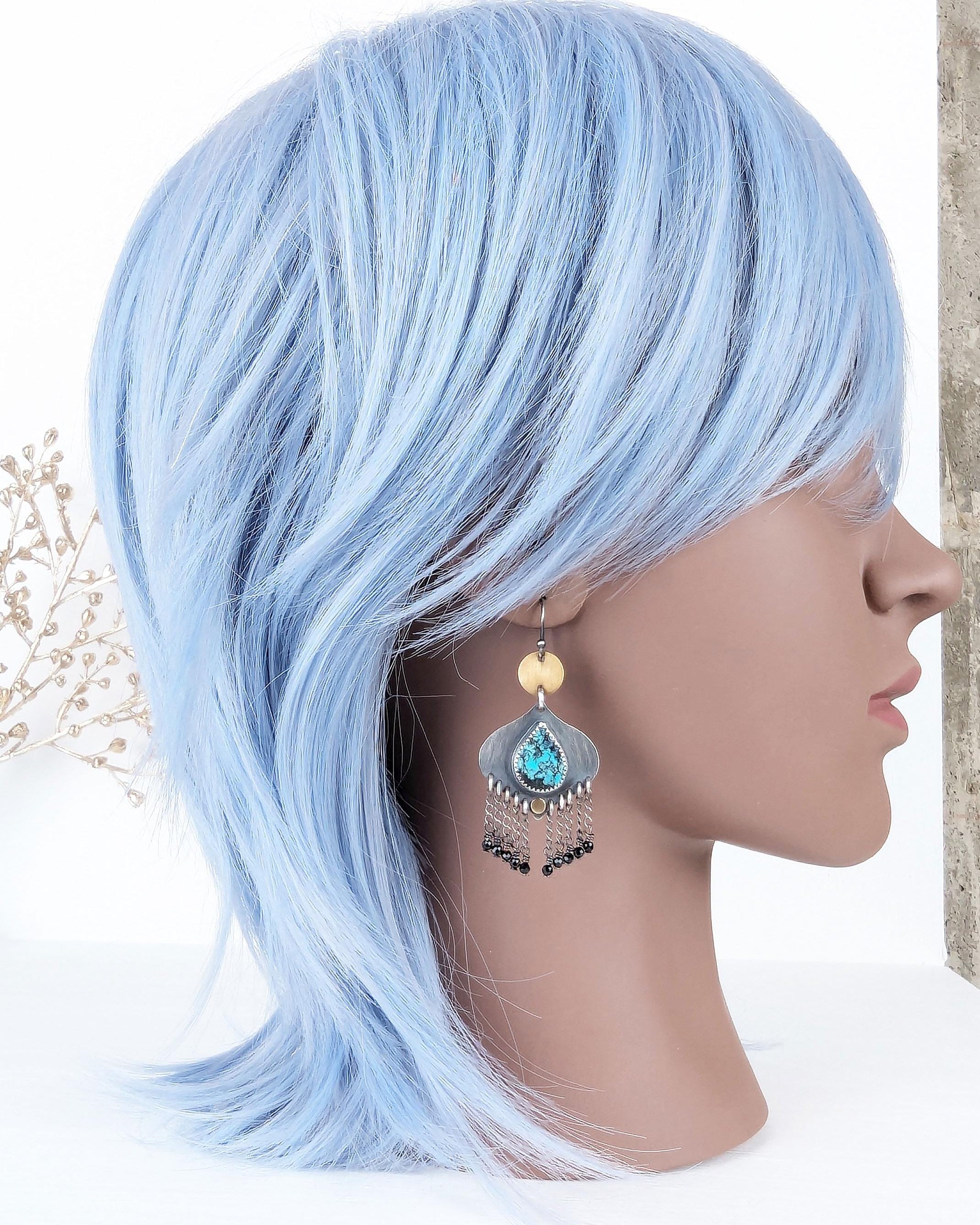 Worldly bohemian earrings with turquoise teardrops and chain fringe on mannequin for scale