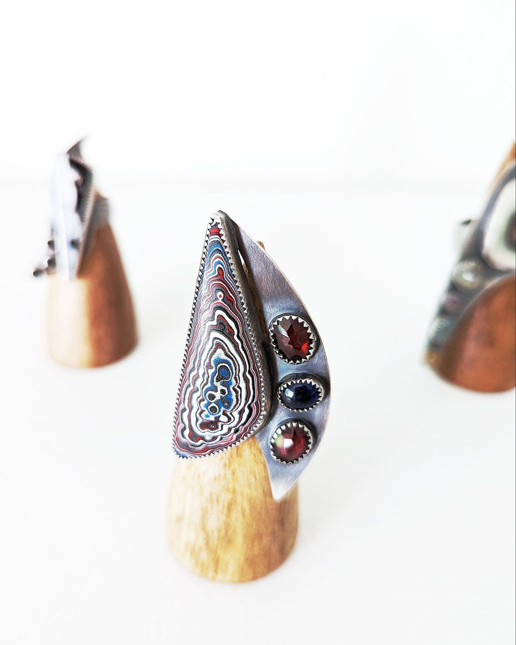 Wide band oxidized sterling silver Fordite statement ring