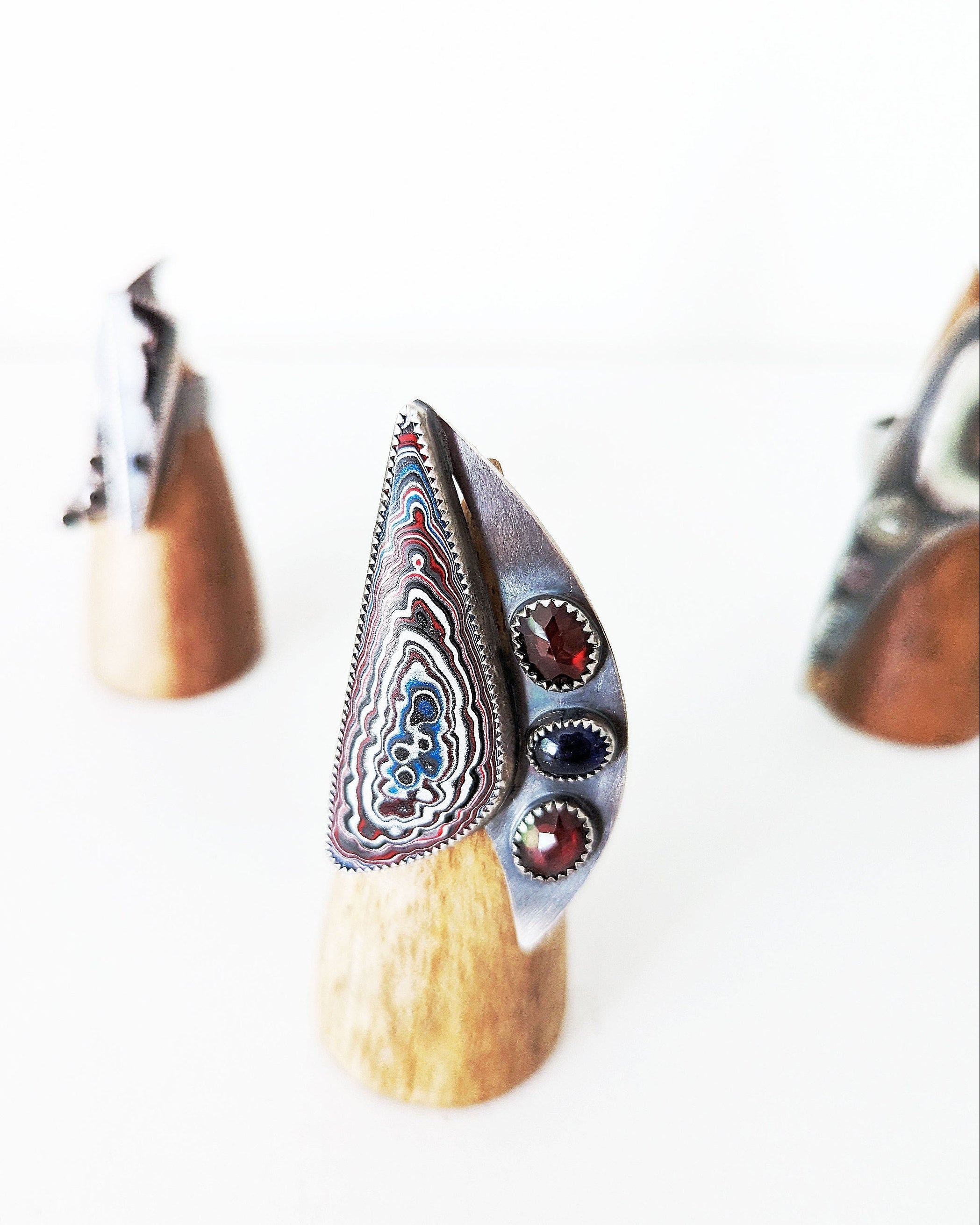 Wide band oxidized sterling silver Fordite statement ring