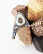 Inverted gemstone settings in large asymmetrical design