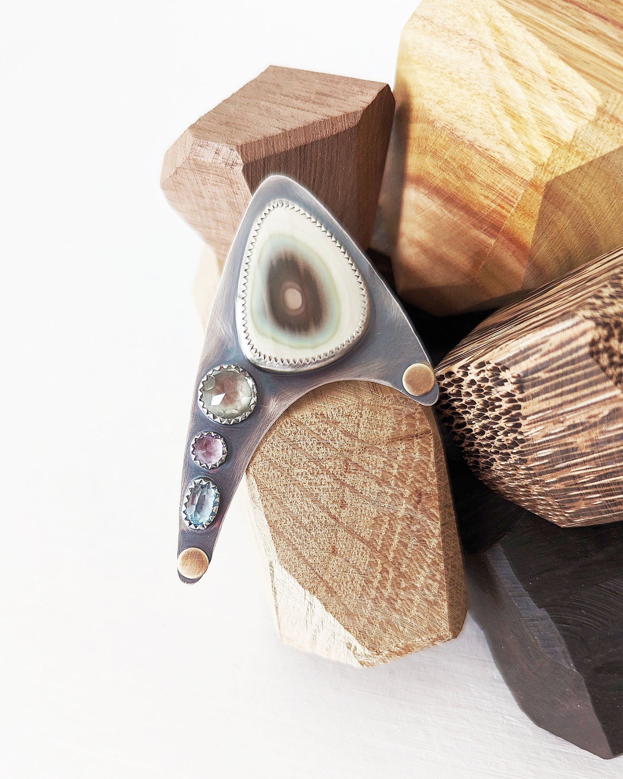 Inverted gemstone settings in large asymmetrical design