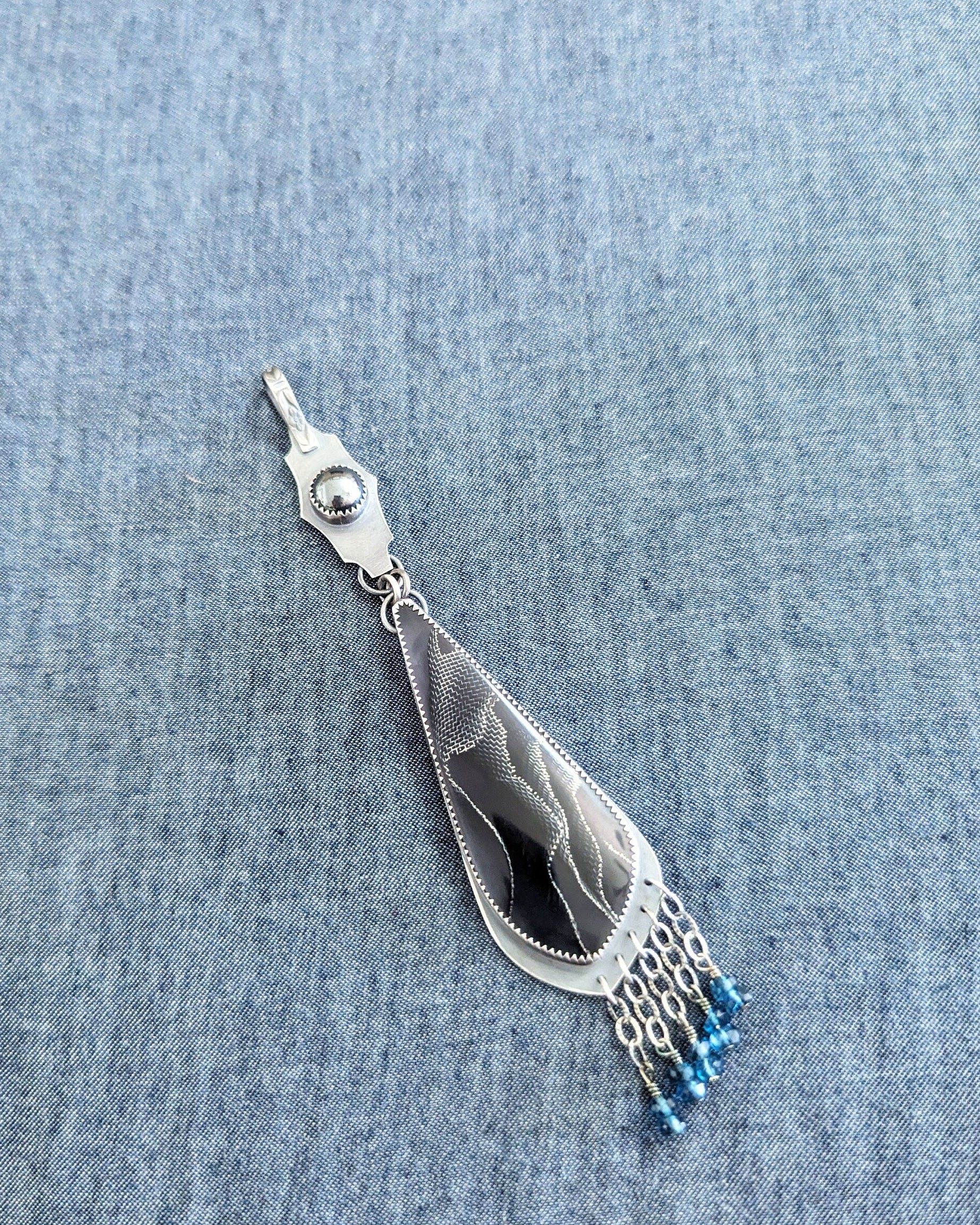Raffir web resin pendant with deep blue grey cabochon and sterling silver fringe