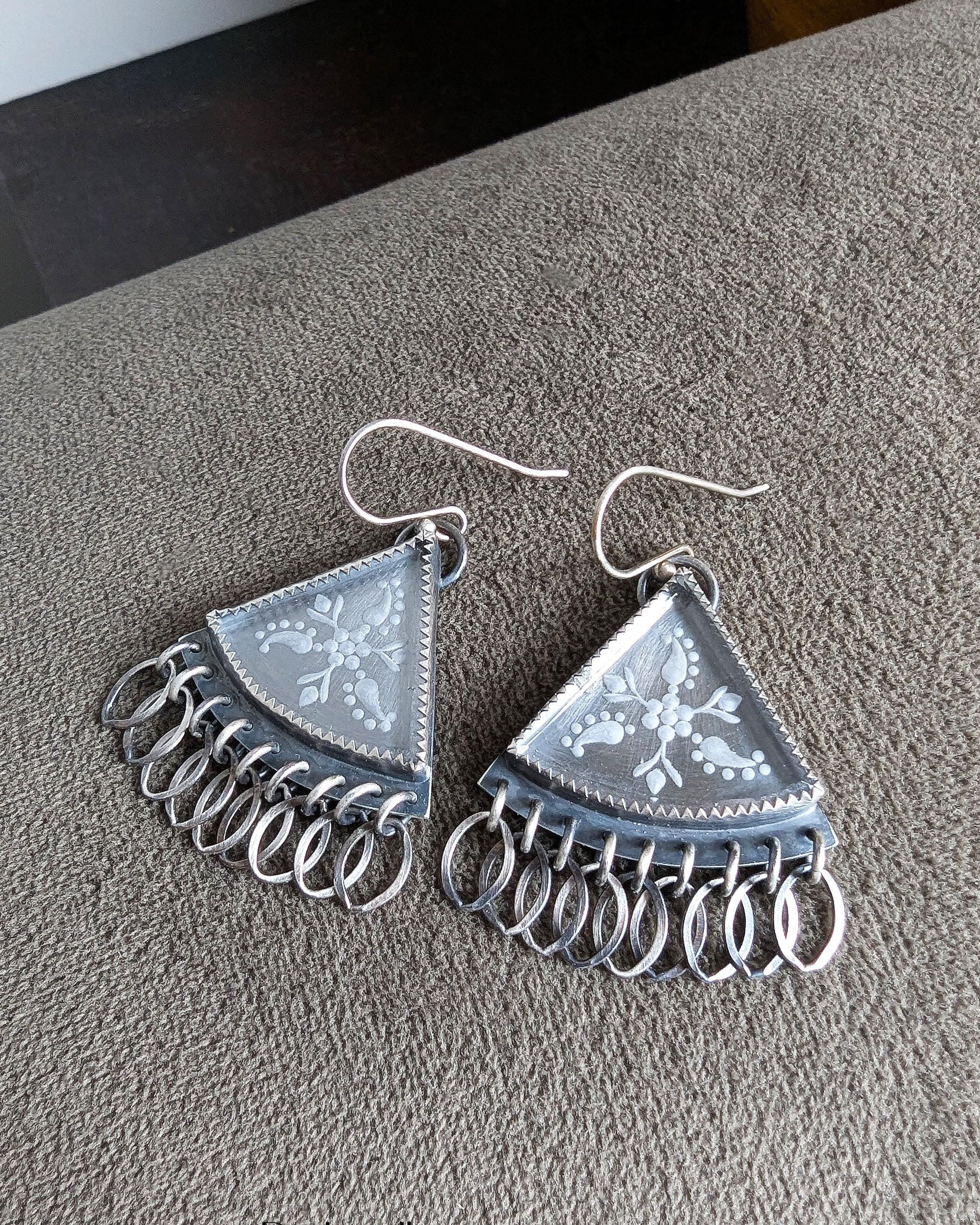 Close-up of floral etched hydro quartz stones in oxidized sterling silver triangle earrings

