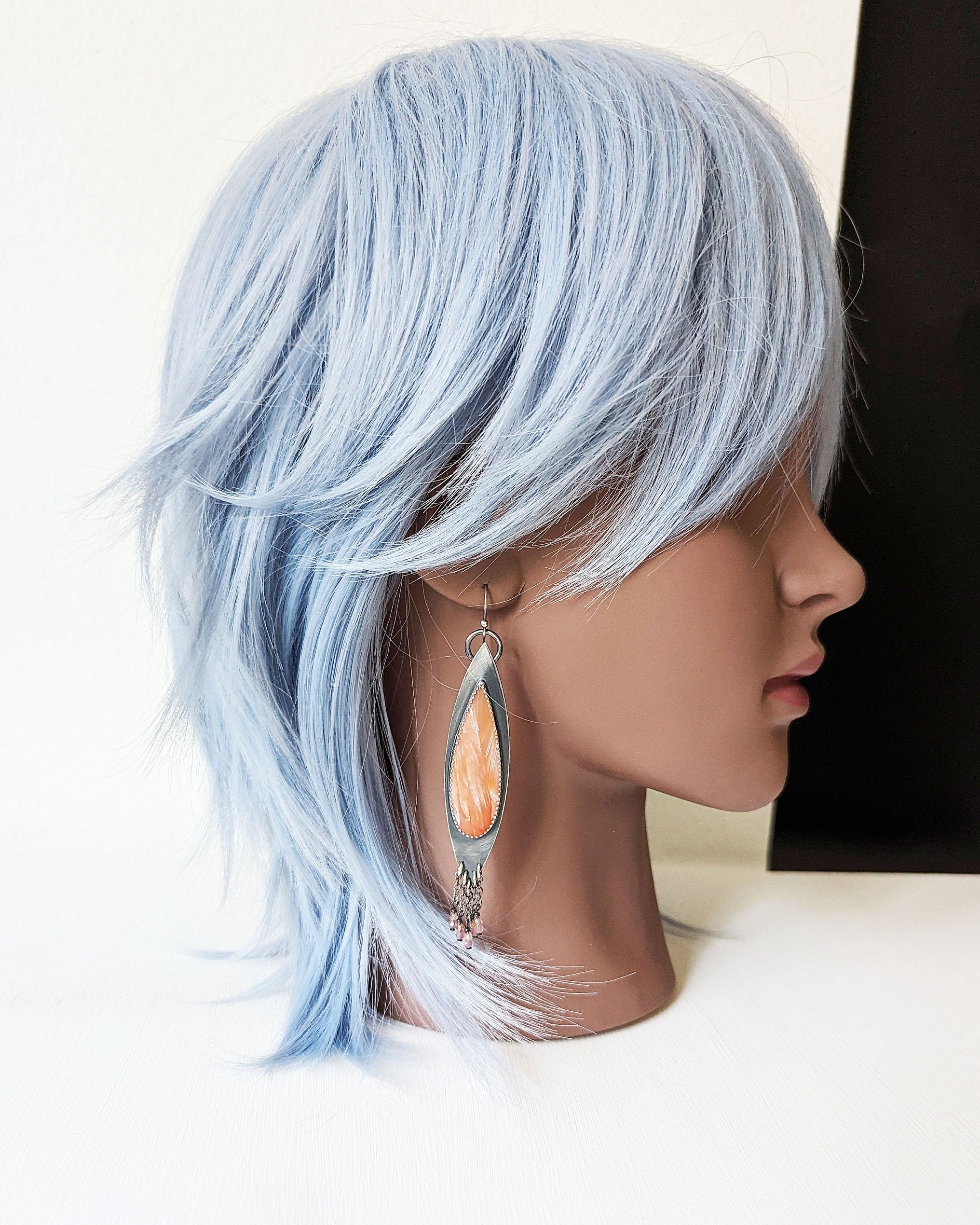 Lightweight sterling silver earrings perfect for beach style on mannequin for scale