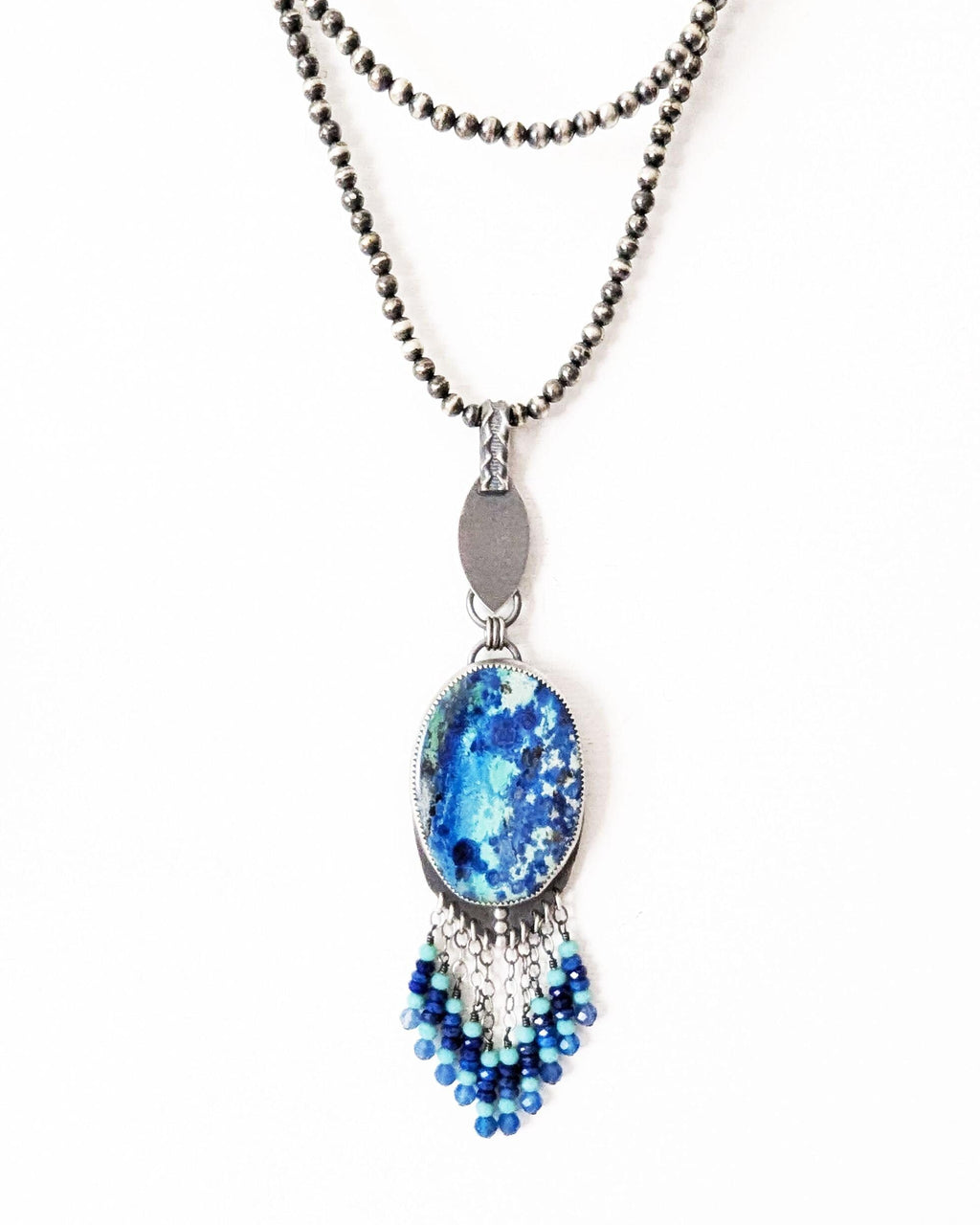 Collector gemstone necklace with vibrant aqua and royal blue tones shown on chain (not included)