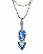 Collector gemstone necklace with vibrant aqua and royal blue tones shown on chain (not included)