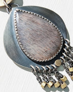 Close up of grey moonstone with copper rutile inclusions