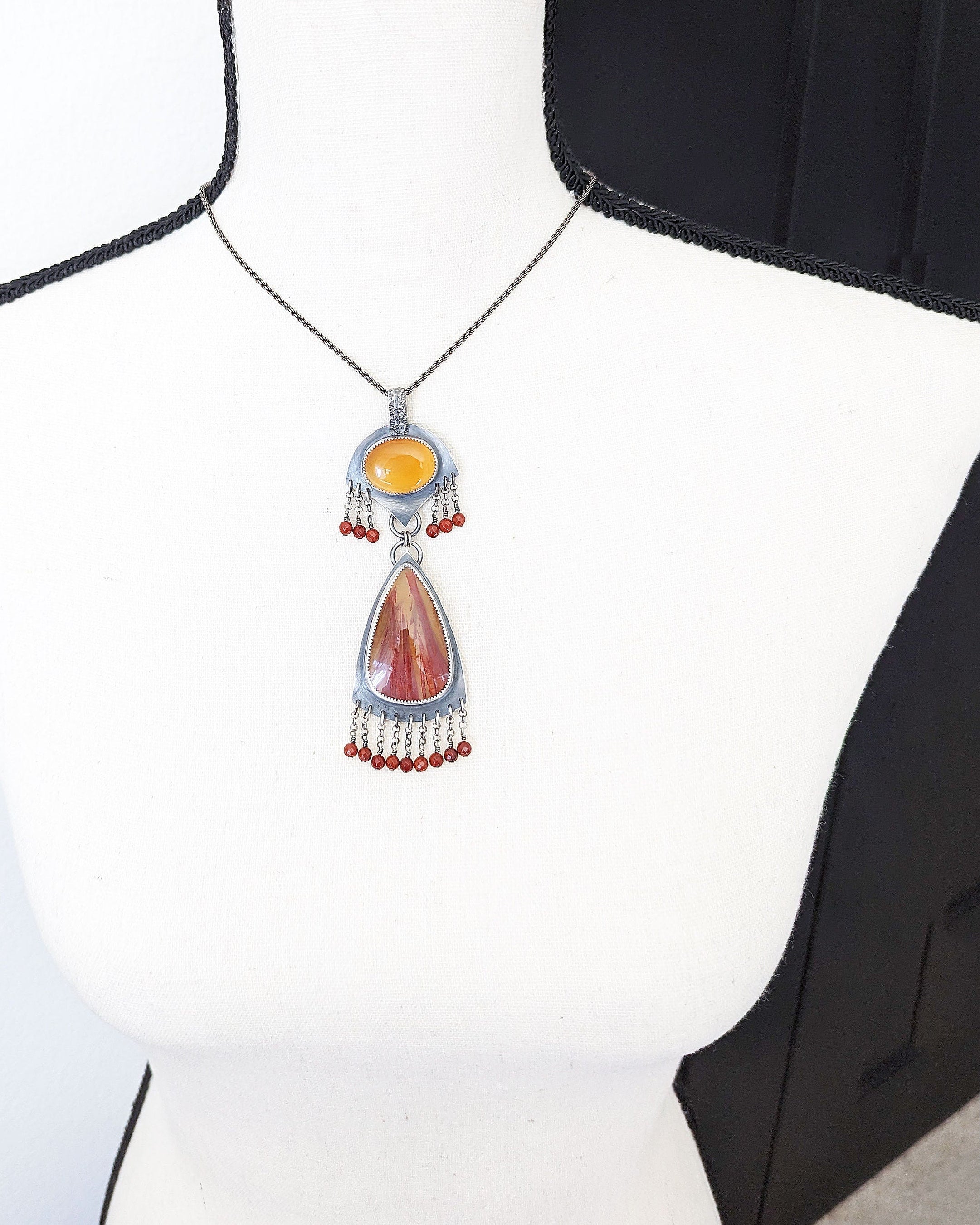 Palm root agate pendant with organic natural pattern on bust for scale