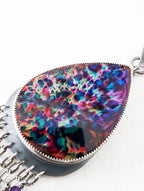 Close up of rainbow labradorite fire and iridescent abalone doublet
