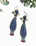 Multi colored sapphire earrings with carved blue floral centerpiece