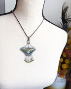 Labradorite pendant worn on chain to show triangular shape and chandelier width on a bust for size
