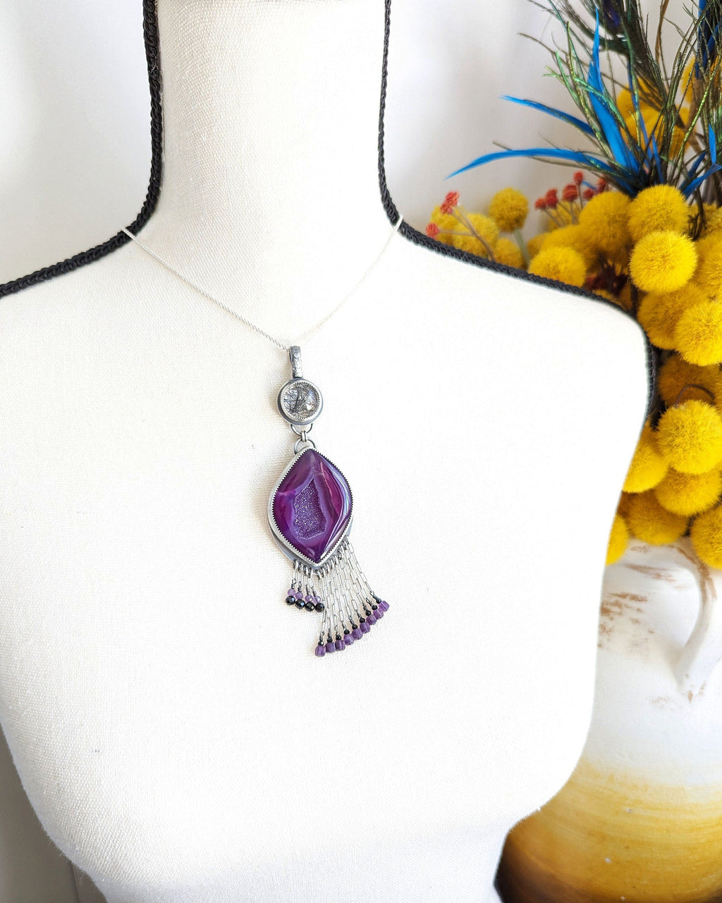 Oxidized sterling silver pendant with druzy agate center and black tourmaline-amethyst fringe shown on bust for size