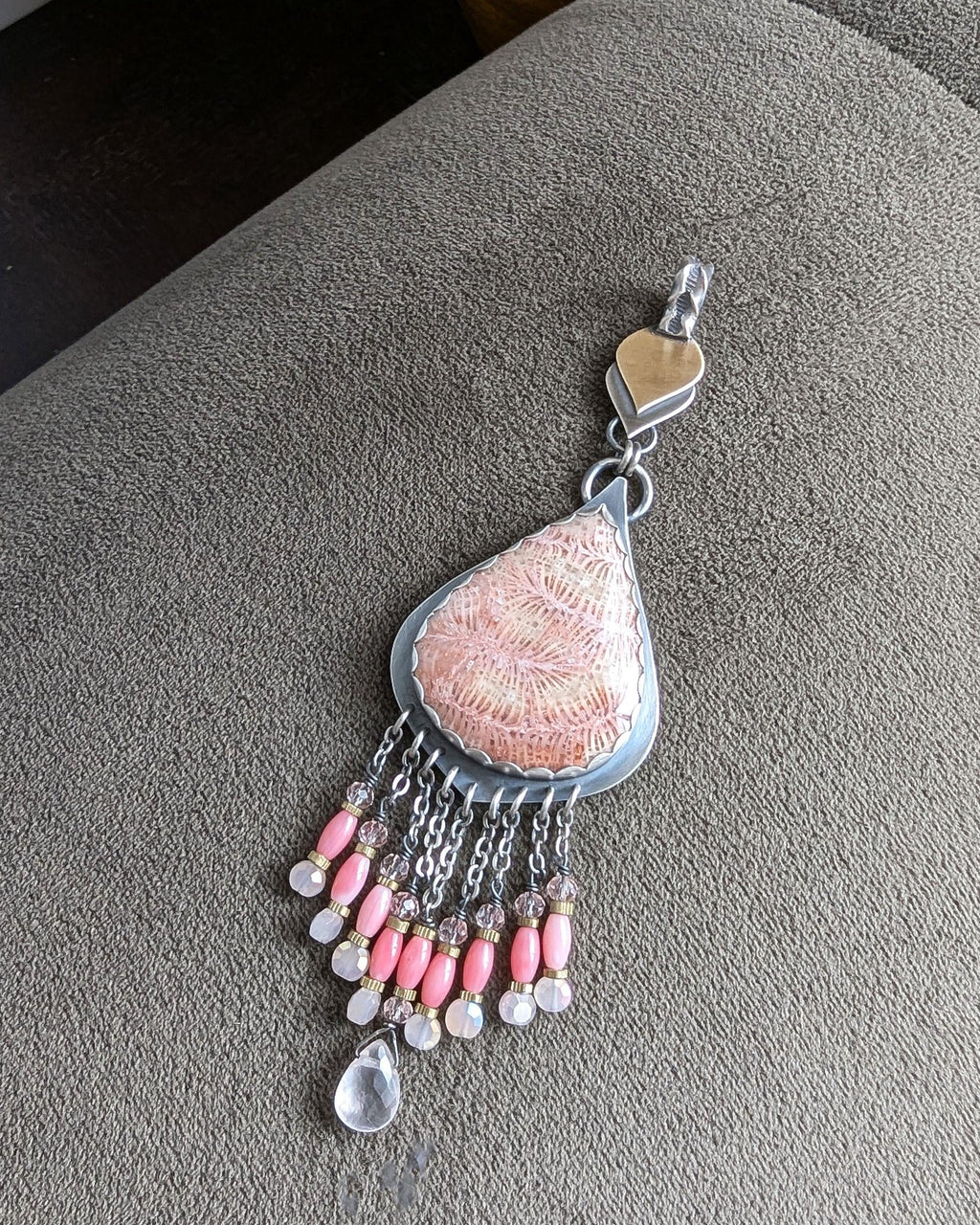 Feminine artisan pendant with warm blush and gold accents