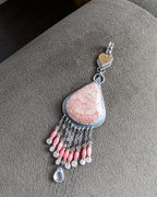 Feminine artisan pendant with warm blush and gold accents