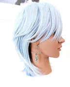Boho western turquoise statement earrings with hammered texture on mannequin for scale