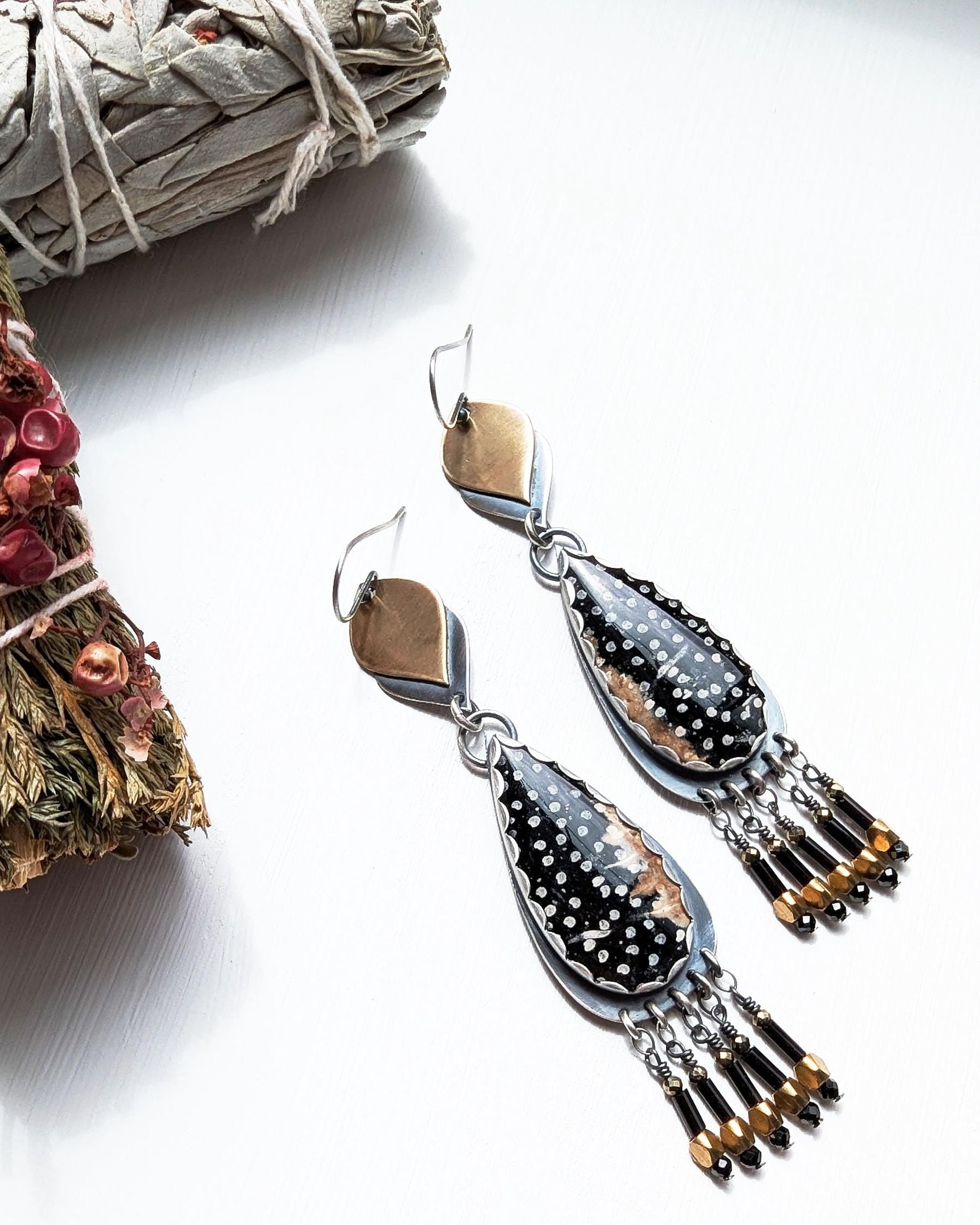 Black spinel and pyrite bead fringe beneath long palm root stone