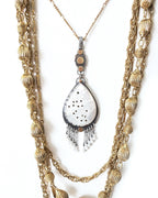 Pear shaped carved mother of pearl pendant in oxidized sterling silver and brass