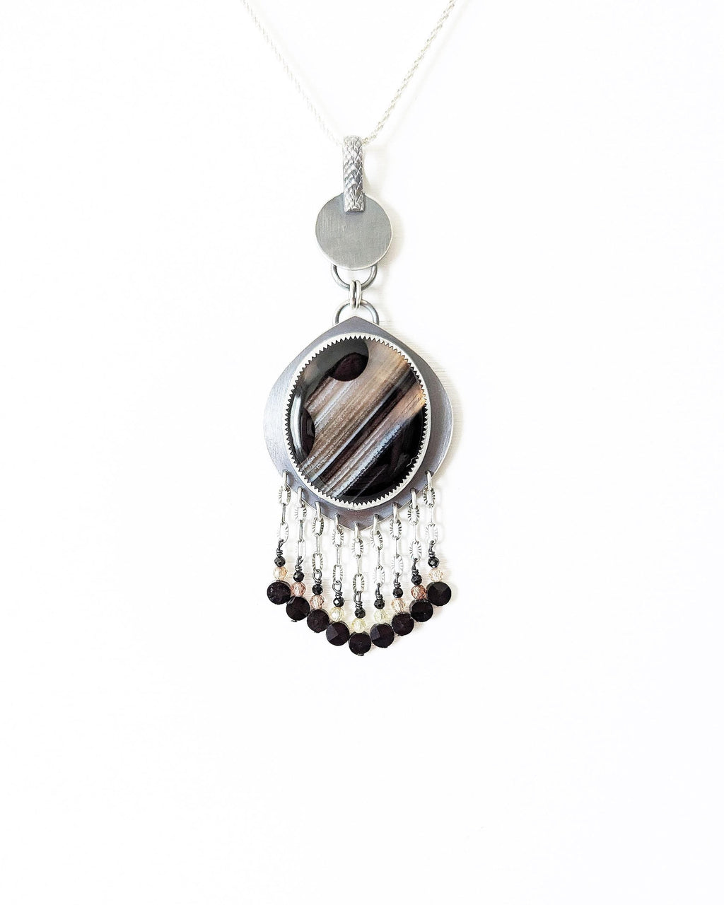 Cosmic-inspired black agate jewelry with artisan silver and beaded accents shown on chain (not included)