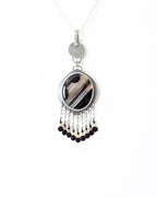 Cosmic-inspired black agate jewelry with artisan silver and beaded accents shown on chain (not included)