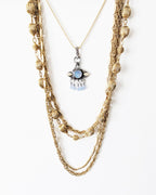 Mystical mixed-metal pendant featuring luminous blue flash on chain with layer necklace (not included)