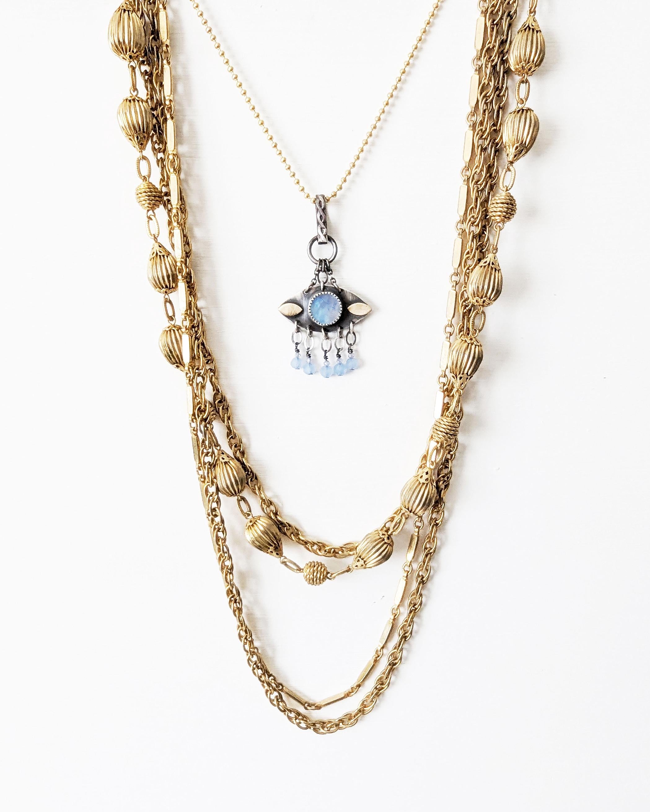 Mystical mixed-metal pendant featuring luminous blue flash on chain with layer necklace (not included)