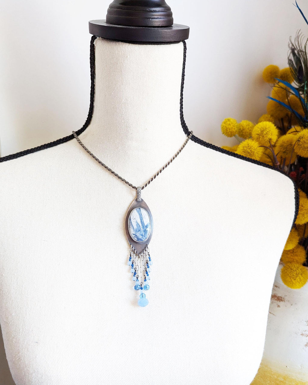 Statement necklace with denim blue kyanite in white quartz on bust for scale
