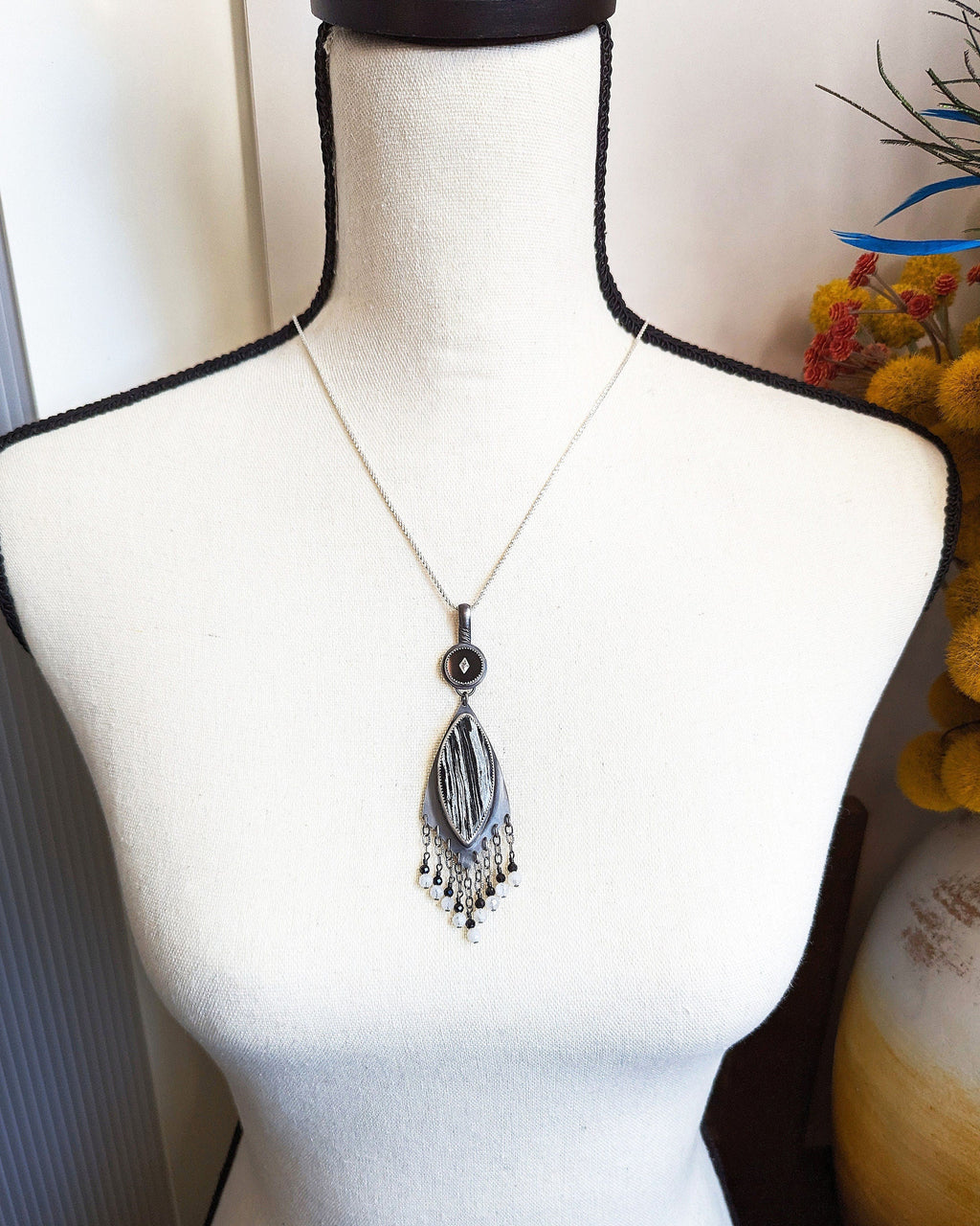 Two-stone sterling silver necklace with vintage glass accent shown on bust for scale
