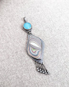 Collector gemstone pendant with layered blue and silver shimmer