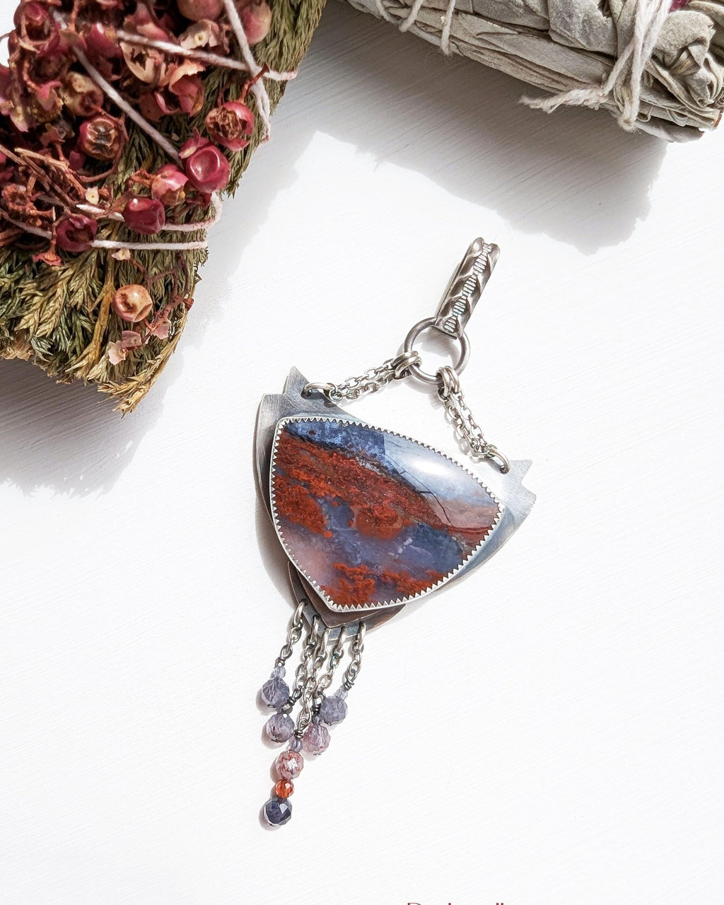 Chocolate garnet and sapphire accents beneath moss agate stone
