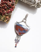 Chocolate garnet and sapphire accents beneath moss agate stone