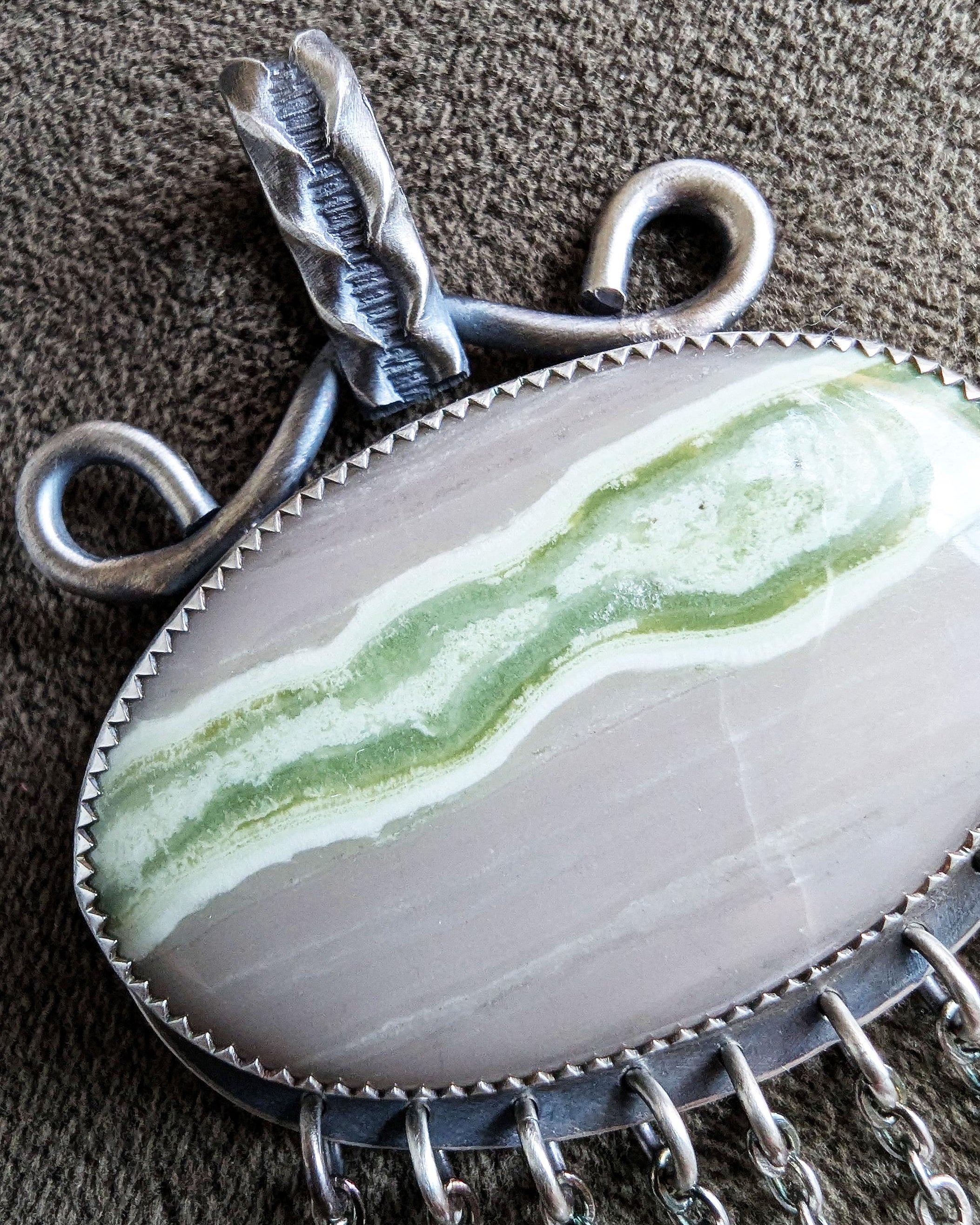 Close up of serpentine stone in artisan pendant