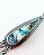 Necklace with marbled stone and chain design on a white background