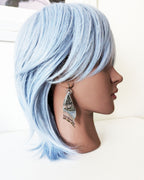 Collector gemstone earrings with shimmering druzy texture on mannequin for scale