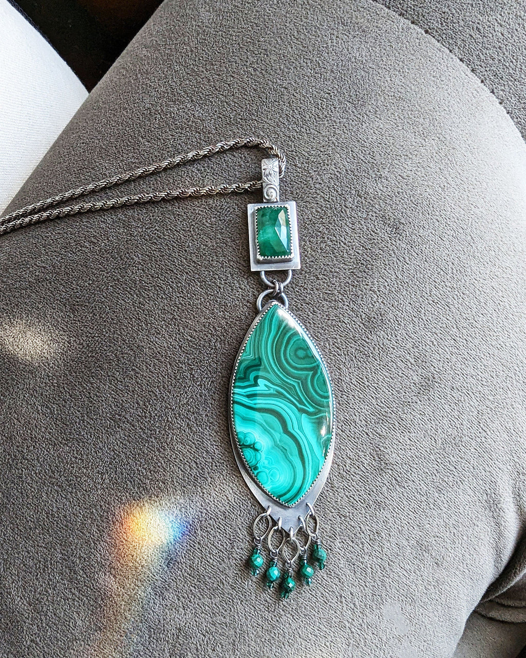 Handcrafted malachite and emerald pendant with ornate silver fringe shown on chain ( not included)