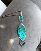 Handcrafted malachite and emerald pendant with ornate silver fringe shown on chain ( not included)