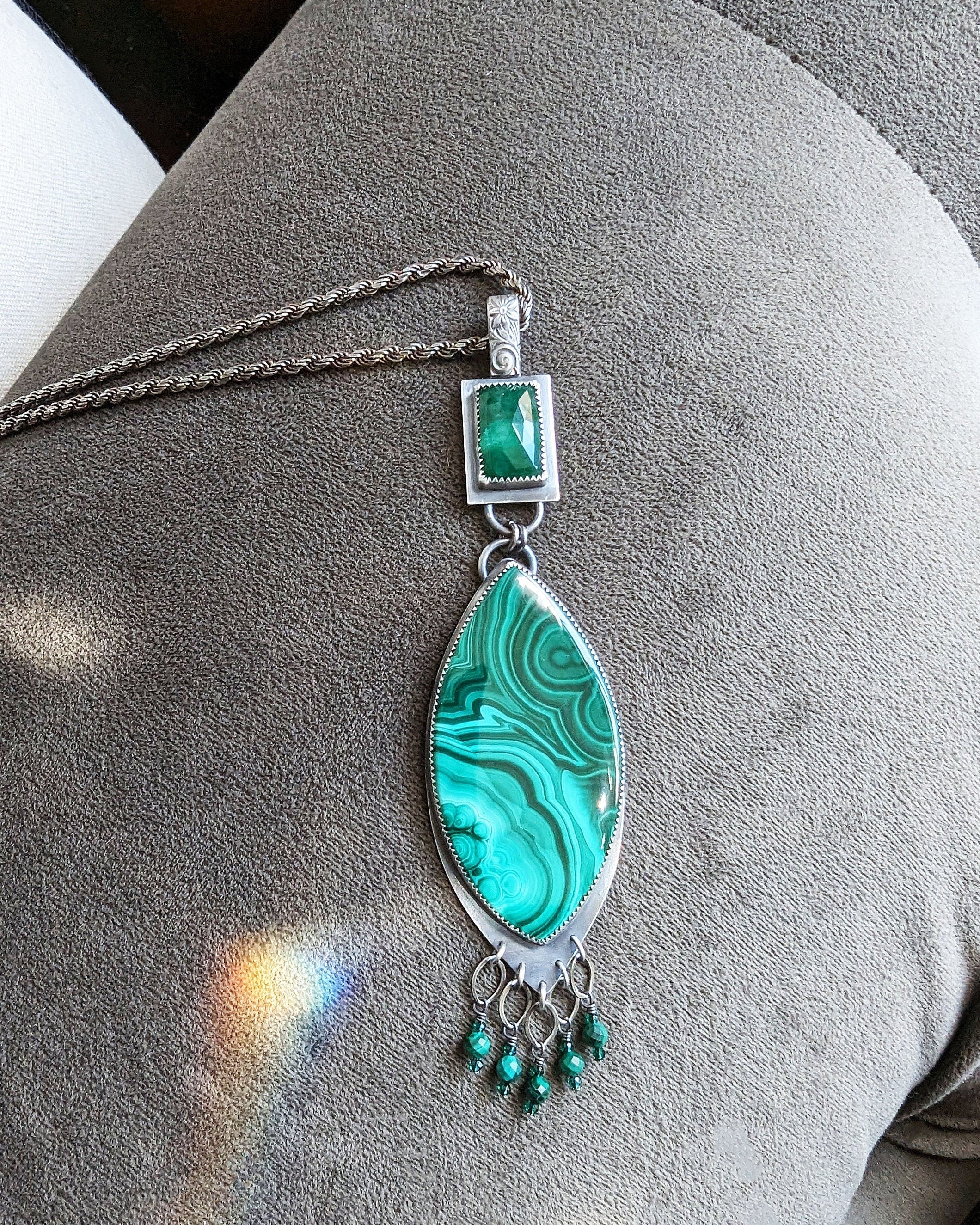 Handcrafted malachite and emerald pendant with ornate silver fringe shown on chain ( not included)