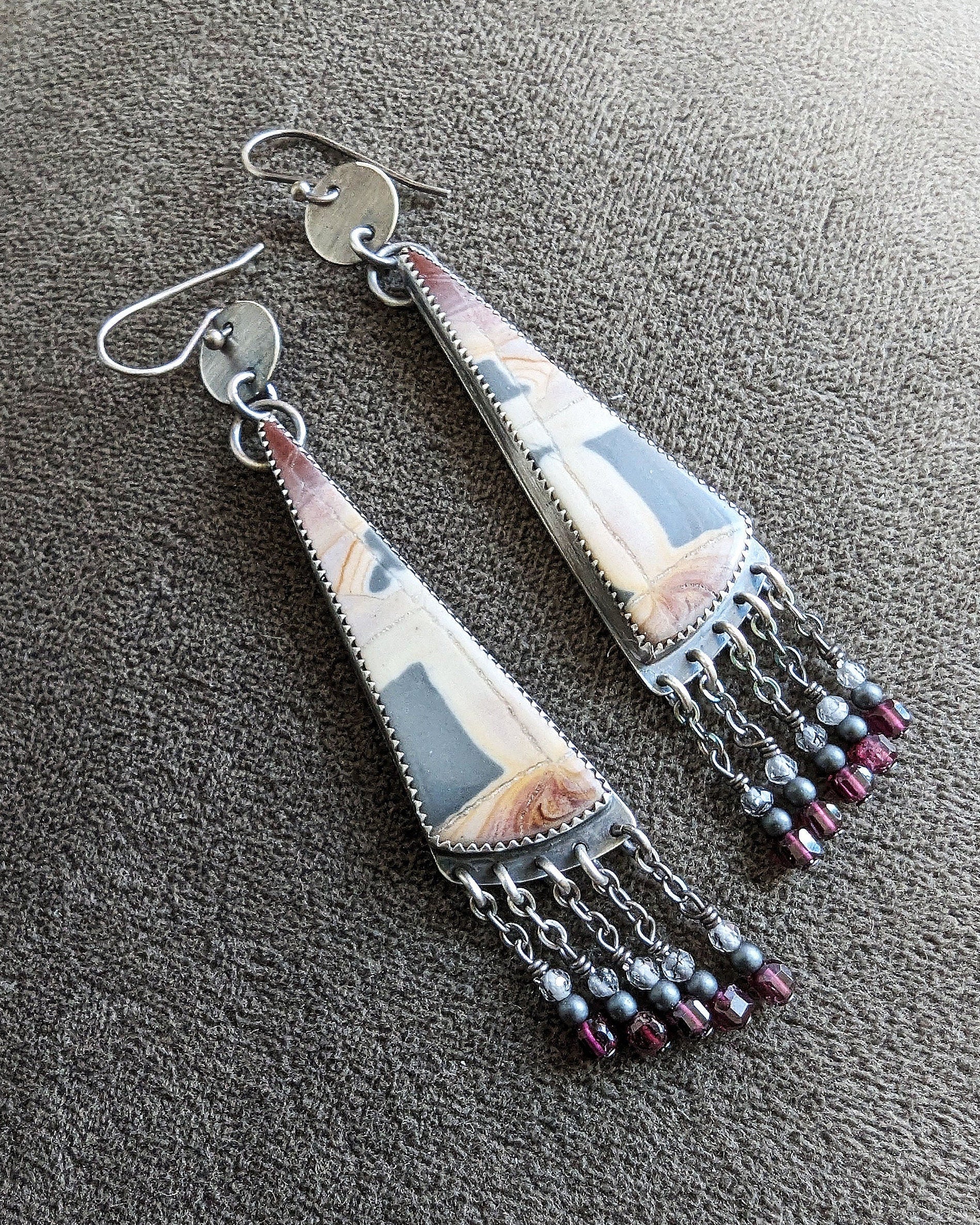 Collector sterling silver earrings with structured yet organic aesthetic
