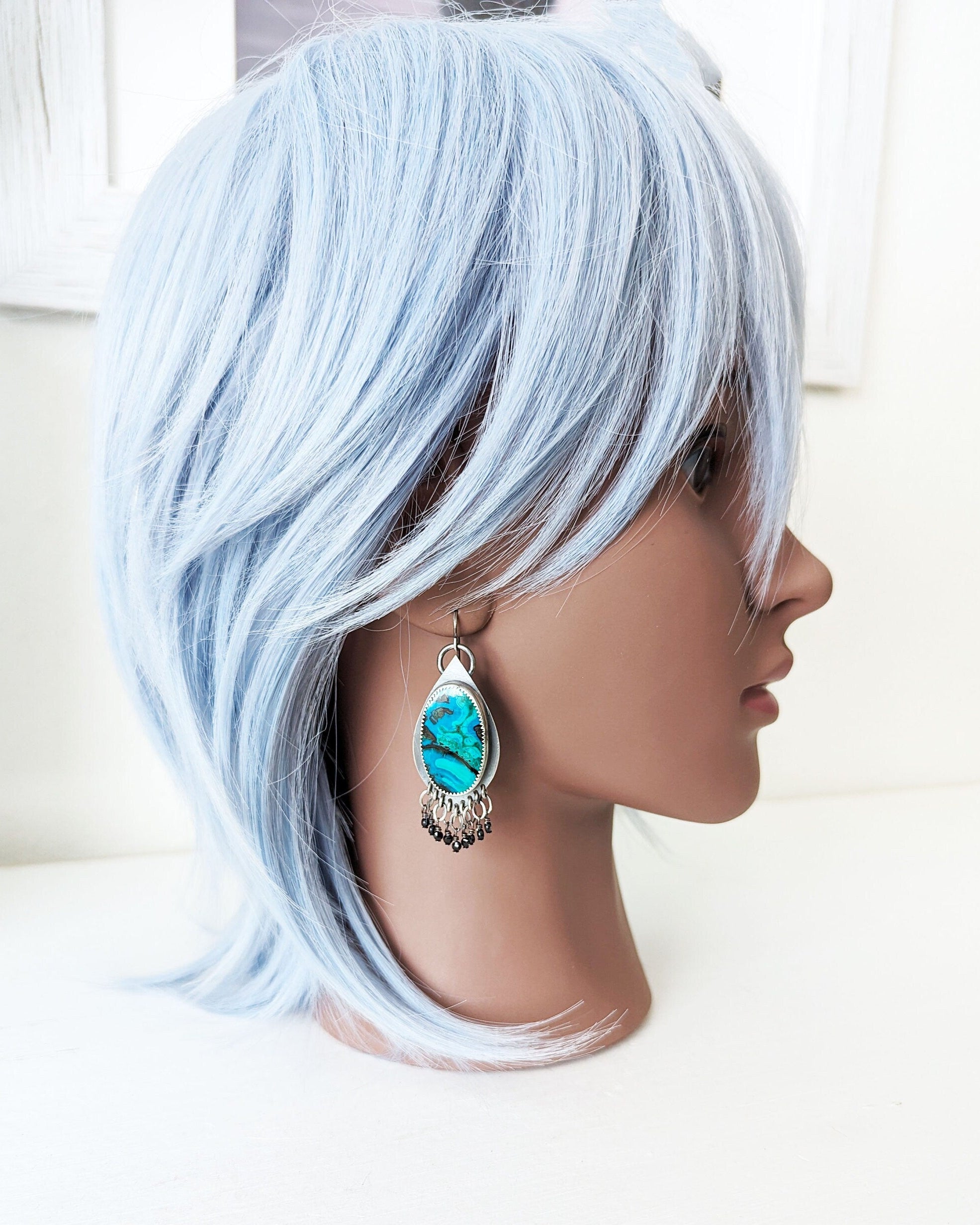 Handcrafted chrysocolla and spinel earrings by Rebellenhaus on mannequin for scale