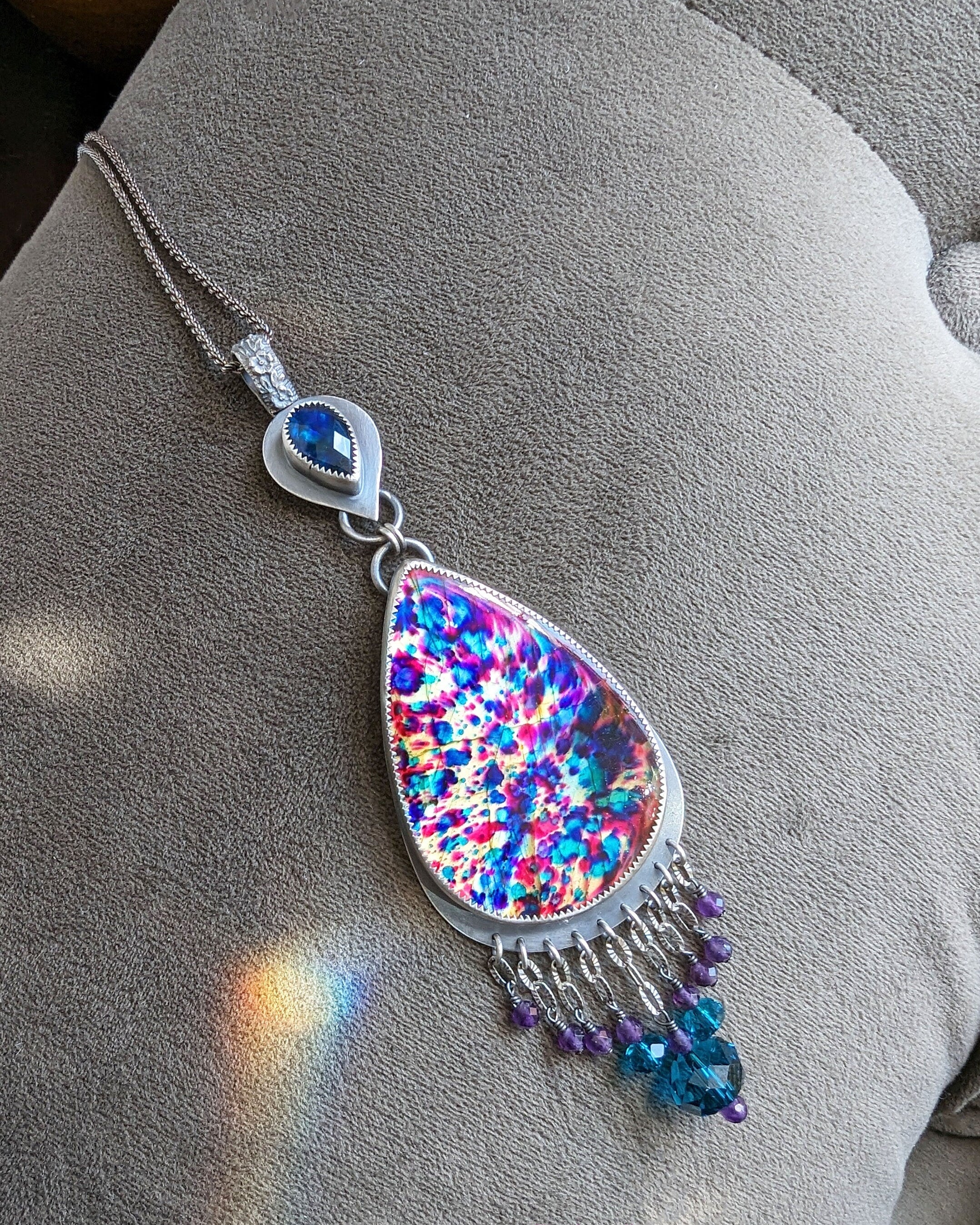 One of a kind rainbow gemstone statement pendant in natural light by Rebellenhaus