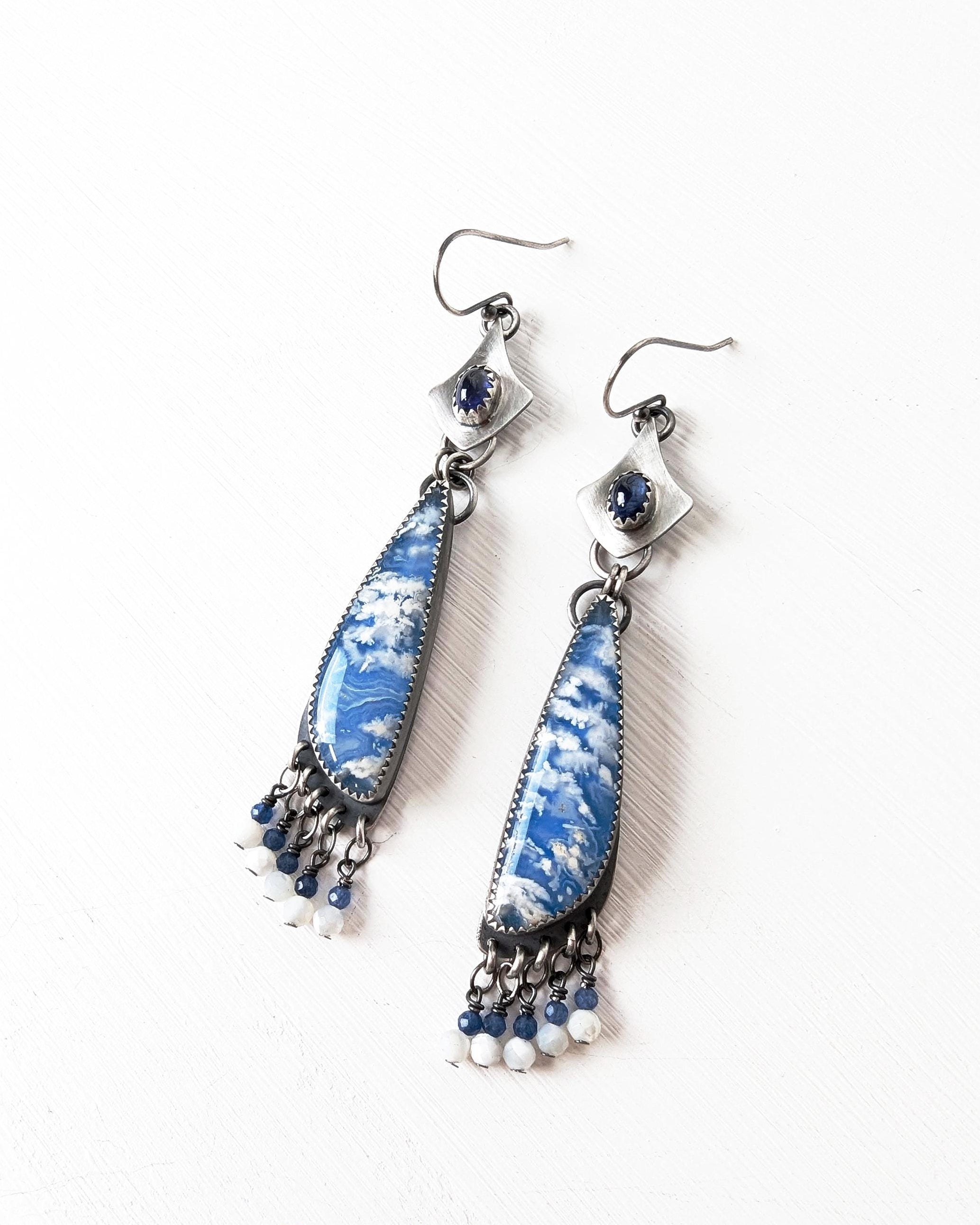 Blue and silver cloud earrings on a white background 
