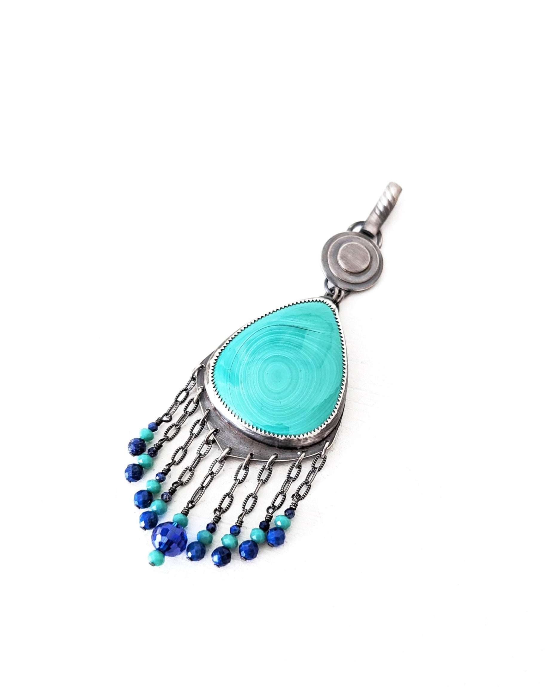 Close up of handmade malachite statement pendant with lapis lazuli and chalcedony accents
