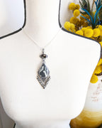 Modern mod statement pendant in black white and silver tones on bust for size (chain not included)