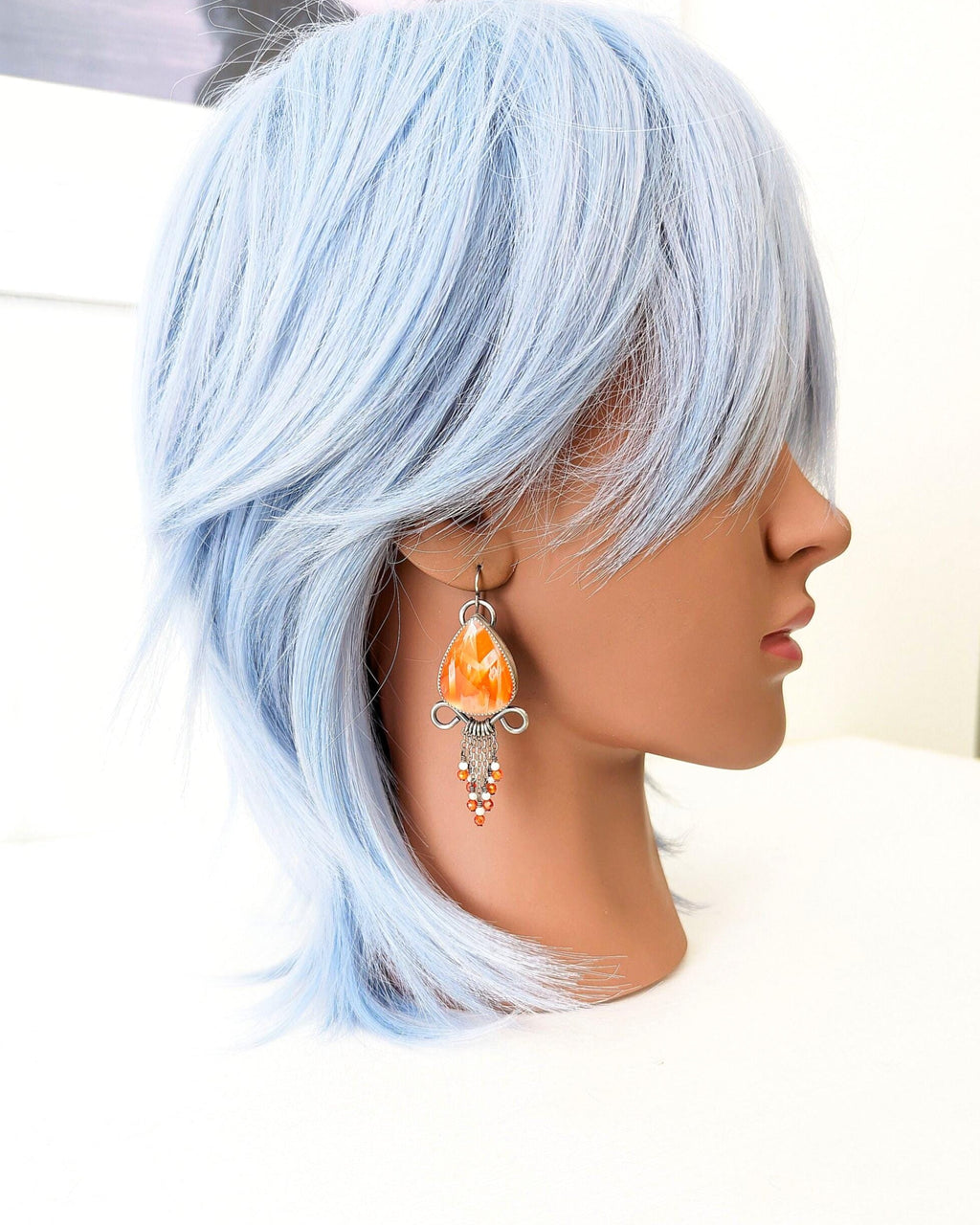 Artisan sterling silver earrings featuring palm agate stone on mannequin for scale