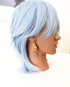 Artisan sterling silver earrings featuring palm agate stone on mannequin for scale