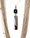 Apache pyrite pendant with vintage 1960s black glass cabochon shown on chain with layer necklace (not included)