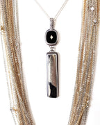 Apache pyrite pendant with vintage 1960s black glass cabochon shown on chain with layer necklace (not included)