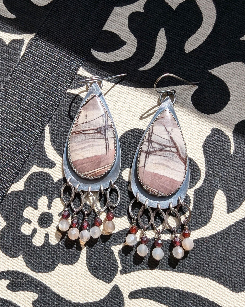 Rhyolite jasper earrings with garnet and moonstone fringe in oxidized sterling silver