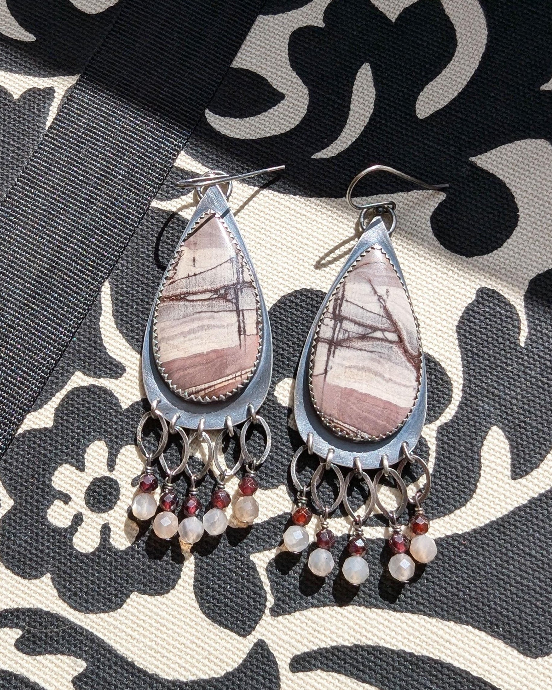 Rhyolite jasper earrings with garnet and moonstone fringe in oxidized sterling silver